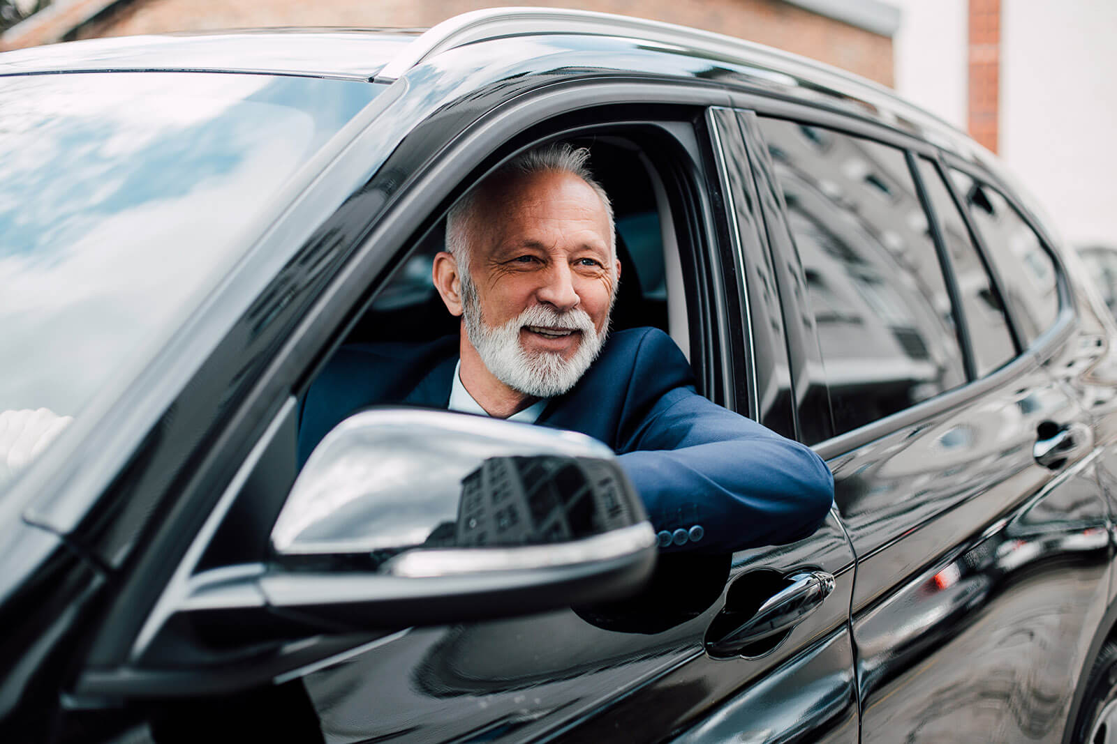 Driver in a black luxury vehicle