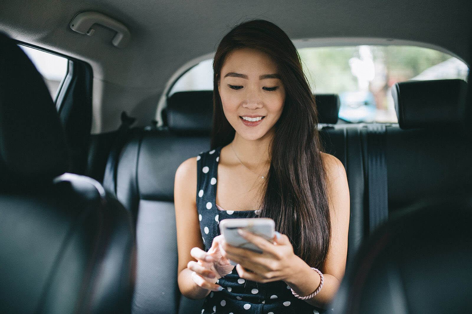 Young student sitting in taxi