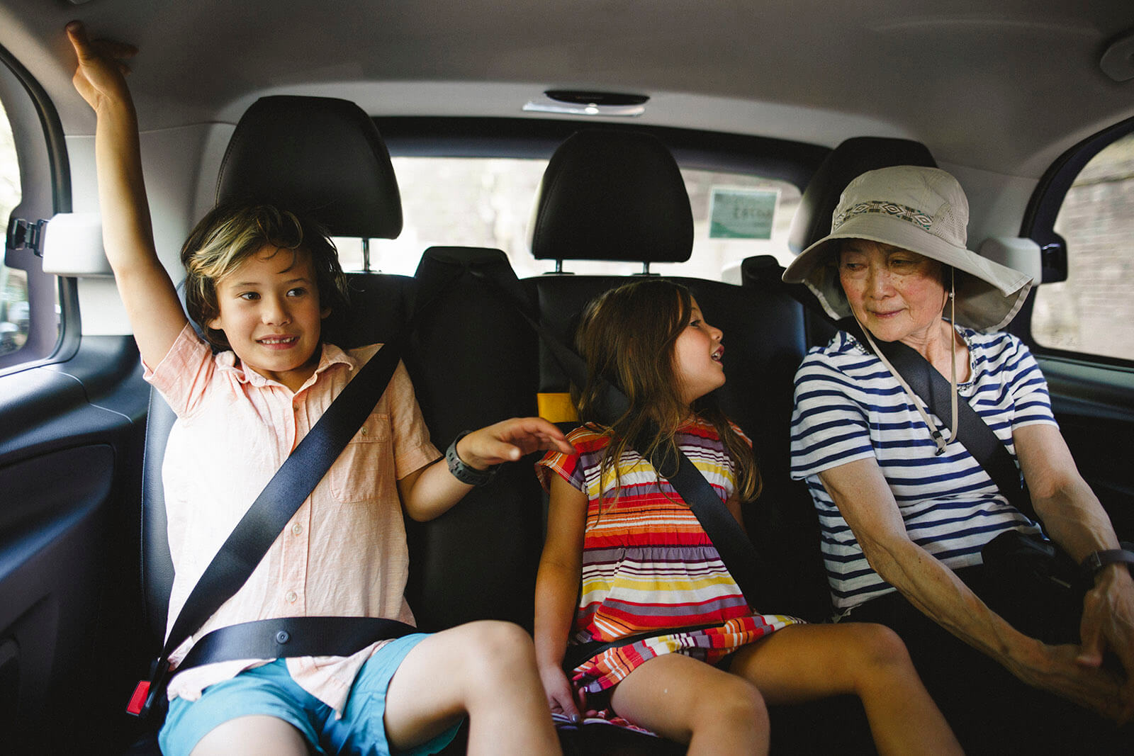 Grandmother with grandchildren traveling in taxi