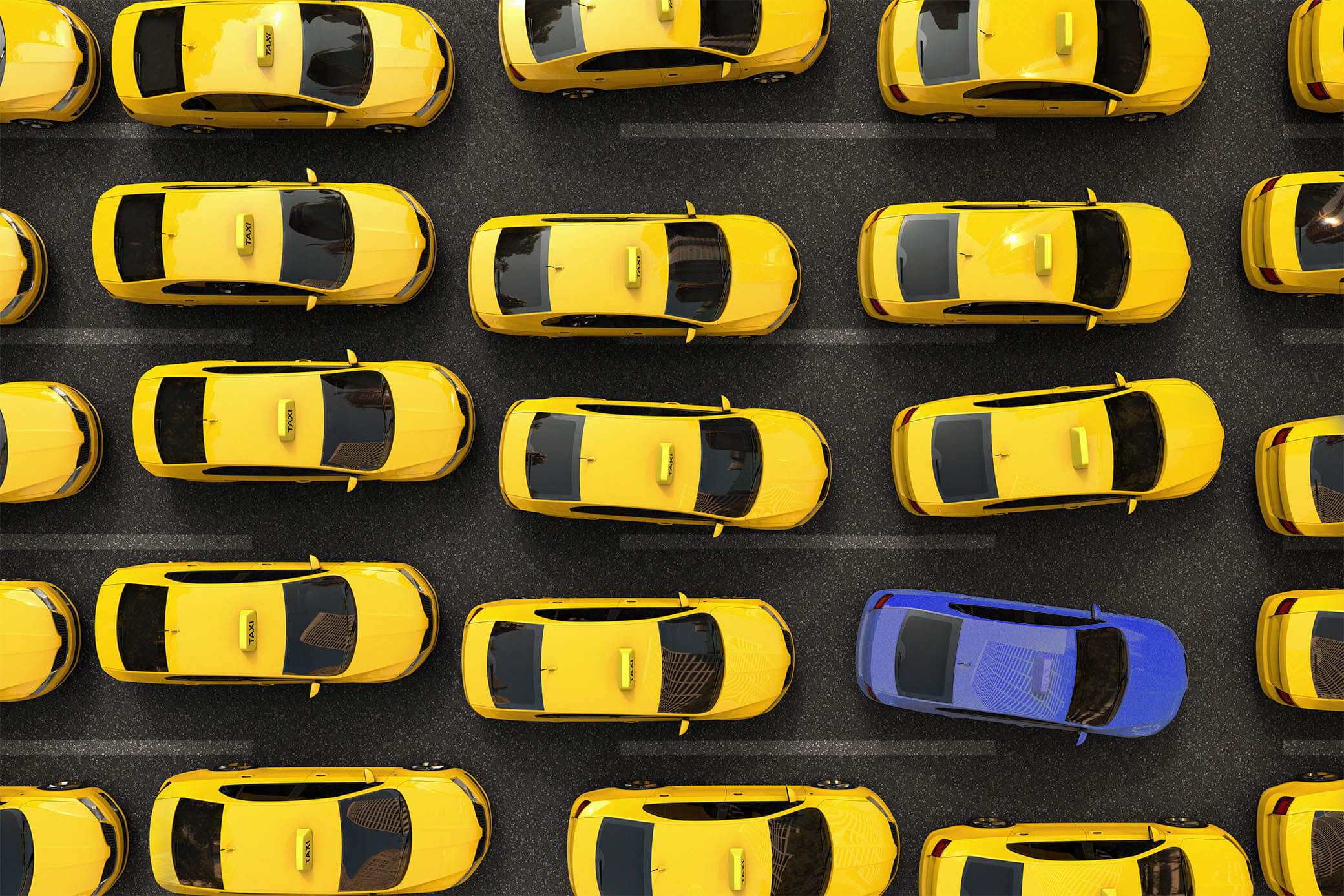 Bird's eye view of yellow cabs with one blue taxi