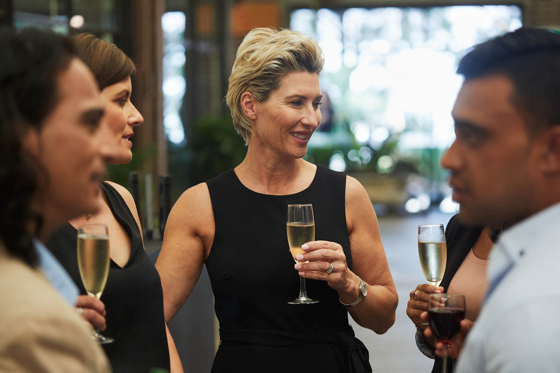 Group of coworkers having champagne at a corporate event